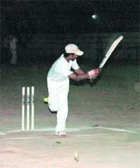 A player hits a shot during the Khalanga day-night cricket tournament in Dehradun