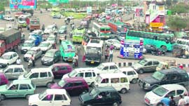 Commuters stranded owing to a long traffic jam in Jammu on Monday. 