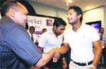 Sri Lankan cricket captain Kumar Sanghakara (R) shakes hands with Pakistani bus driver Mohammad Khalil, who drove the team to safety during the Lahore attack, at a ceremony held to felicitate Khalil in Colombo. 