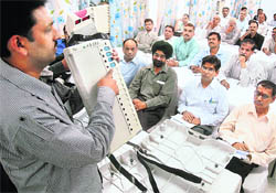 An official explains the operation of the Electronic Voting Machine at the training centre in Punjab Engineering College, Sector 12, Chandigarh.