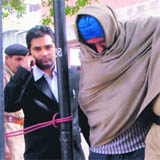 Paramjit Singh wrapped in a shawl to protect his burn injuries.