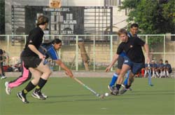 German tourists play a friendly hockey match with a local team at Gurgaons Nehru Stadium
