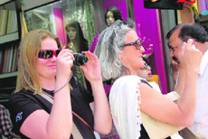 Foreigners click photographs at a shop in Dehradun on Tuesday.