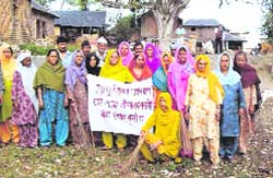 Members of the mahila mandal of the Anoh gram panchayat participate in a sanitation drive at Nurpur
