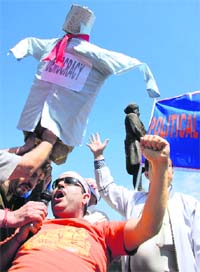 Kashmiri Pandits express their anger against the tedious voting procedure by burning an effigy of Indias democratic system in Jammu