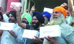 Sikhs shout slogans against Congress leaders Jagdish Tytler and Sajjan Kumar for their alleged roles in the 1984 anti-Sikh riots before sending 10 shoes to Congress president Sonia Gandhi as a mark of their protest against partys decision to give tickets to the two leaders in the Lok Sabha elections, at Gole Dak Khana in New Delhi on Wednesday. 