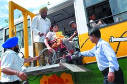 Handicapped children enjoy a ride in Ashok Leylands newly launched " Fun Bus" during a picnic at Indraprastha Park in New Delhi on Wednesday. 