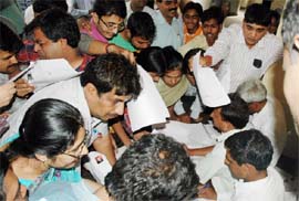 LAST-MINUTE RUSH: Voters jostle to get their identity cards made minutes before the expiry of the deadline at Mini Secretariat in Gurgaon on Wednesday.