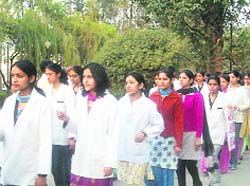 Students of Dr RP Government Medical College take out a candlelight procession to mark one month of Aman Kachroos death at Tanda on Wednesday.