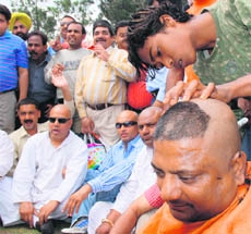 Activists get their heads shaved against the fee hike in Ludhiana on Wednesday.