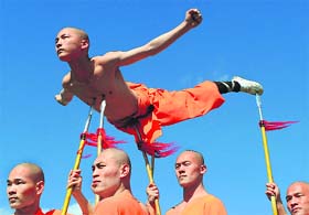 Shaolin Wu-Shu Warriors lift a colleague using spears at the Chinese State Circus at Alexandra Palace in London