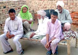 The ill-fated members of the family sit on a cot at their residence in Jeeda village, 20 km from Bathinda, on Thursday.