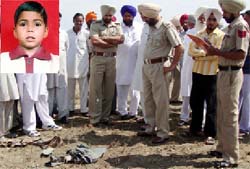 Police investigating the incident of a 14-year old child (inset) devoured by stray dogs at village Samadh Bhai in Moga district on Wednesday.