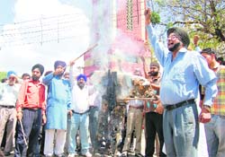 An effigy of Congress leader Jagdish Tytler being burnt in Dehradun on Thursday. 