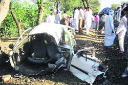 The mangled remains of the car that was hit by a train on an unmanned railway crossing near Bhangu village in Sirsa