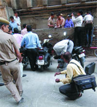 Police inspects the place where a man jumped off the 17th floor of a building in CP in New Delhi on Friday.