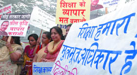  Parents of schoolchildren shout slogans during a demonstration to protest against hike in fee by private schools, at Jantar Mantar in New Delhi on Friday.
