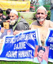 Family members of missing youths hold a protest in Srinagar on Friday.
