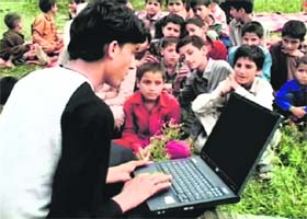 Children attend a computer class at a government primary mobile school in Mansar on the outskirts of Jammu