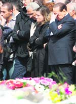 Italys Prime Minister Silvio Berlusconi (right) reacts during the state funeral ceremony following the earthquake in Aquila on Friday. Italy held a state funeral on Friday for victims of its worst earthquake in three decades, as the death toll climbed to 289. 