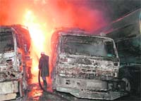 A Pakistani firefighter tries to extinguish burning oil supply tankers after a late night blast on the outskirts of Peshawar on Friday. 