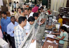 Customers await their turn at the Main Post Office in Bathinda on Thursday.