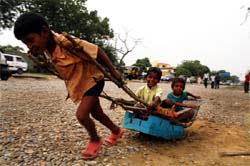 Children of labourers have a good time on a road in Gurgaon