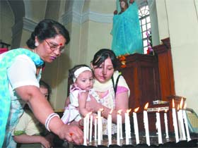 Christian devotees light candles at the Sacred Heart Cathedral on the occasion of Easter in New Delhi