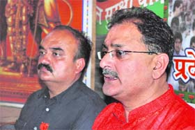 Mayor Kavinder Bhushan Gupta (right) canvasses support for BJP candidate Leela Karan Sharma in Jammu