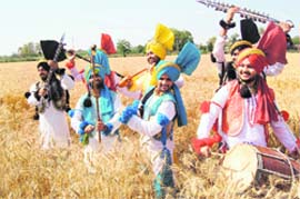 Farmers perform bhangra in the fields on the eve of Baisakhi.
