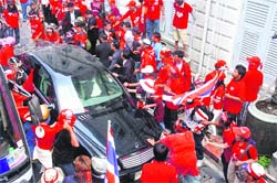 Supporters of ousted Thai Prime Minister Thaksin Shinawatra beat up an occupant of a government vehicle after dragging him out of the car at the Interior Ministry in Bangkok on Sunday