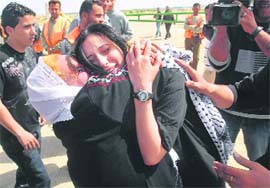 Released Palestinian prisoner Shereen Khalifa (right) is greeted by her mother on her arrival at the Erez border crossing in the northern Gaza strip on Sunday. Khalifa, a member of President Mahmoud Abbas Fatah movement, was released from an Israeli jail on Sunday after serving a six-year sentence. 