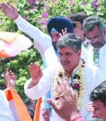 Sandeep Diskhit greets people while on the way to filing his nominations in New Delhi. 