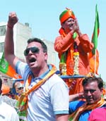 BJP East Delhi candidate and former cricketer Chetan Chauhan greets people before filing nominations in New Delhi.