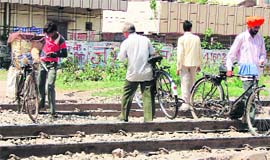 Unmindful of the danger to their lives, local residents pass a level crossing in Ambala City. 