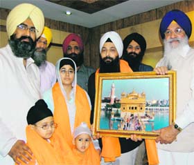 Jarnail Singh (in white turban), along with his family, being honoured by SGPC chief Avtar Singh in Amritsar