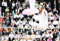 South Korean tightrope walker Kim Dae-Kyun sits on a rope during Spring Festival in Seoul, South Korea, on Monday.