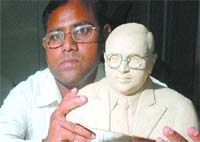 Paying Tributes: Dr Charanjit Mann, a resident of Lesriwal village, near Adampur, shows his creation, a bust of Dr B.R. Ambedkar, to commemorate the birth anniversary of the latter