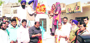 Lok Sabha Deputy Speaker Charanjit Singh Atwal pays tributes to B.R. Ambedkar at Jagera Road in Ahmedgarh on Tuesday.