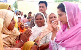 Harsimrat Kaur Badal, SAD-BJP candidate for Bathinda Lok Sabha seat, listens to problems of people in village Goniana Khurd during her election campaign on Wednesday.