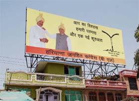 HJC chief Kuldeep Bishnoi stands tall in a hoarding displayed at Gurgaon-Delhi Expressway near Raj Nagar