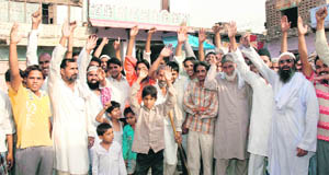 Villagers raise slogans against the power authorities in Sakras village in Nuh district on Thursday.
