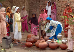 Women and girls of Sakras village in Nuh fetch water from a handpump on Thursday.
