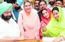 Congress candidate from Patiala Preneet Kaur (right), accompanied by husband and former Chief Minister Amarinder Singh, files nomination in Patiala on Thursday.
