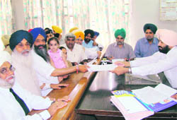 SAD candidate from Patiala Prem Singh Chandumajra (third from left), accompanied by Chief Minister Parkash Singh Badal, files nomination in Patiala on Thursday.