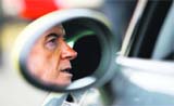 Britains Business Secretary Peter Mandelson is reflected in a wing mirror as he sits in an electric mini car at Knockhill racing circuit in Fife, Scotland