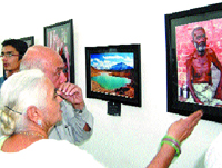 Visitors view photographs by Aayush Goel during a photo exhibition in Amritsar.