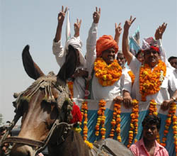Lok Janshakti Party candidate Yashpal Prajapati rides on a mule cart to file his nomination from the Gurgaon Lok Sabha seat, at Mini Secretariat on Friday.
