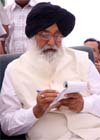 Chief Minister Parkash Singh Badal notes down points at an election rally in the grain market at Bathinda