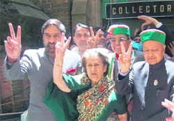 Congress Shimla candidate Dhani Ram Shandil flashes victory sign after filing his nomiation papers at the DC office in Shimla